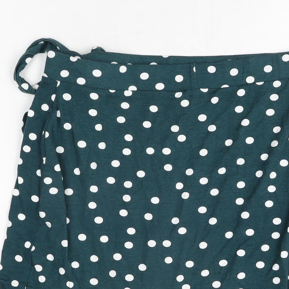 Brand and care label for ASOS women’s green polka dot viscose mini skirt, size UK 12