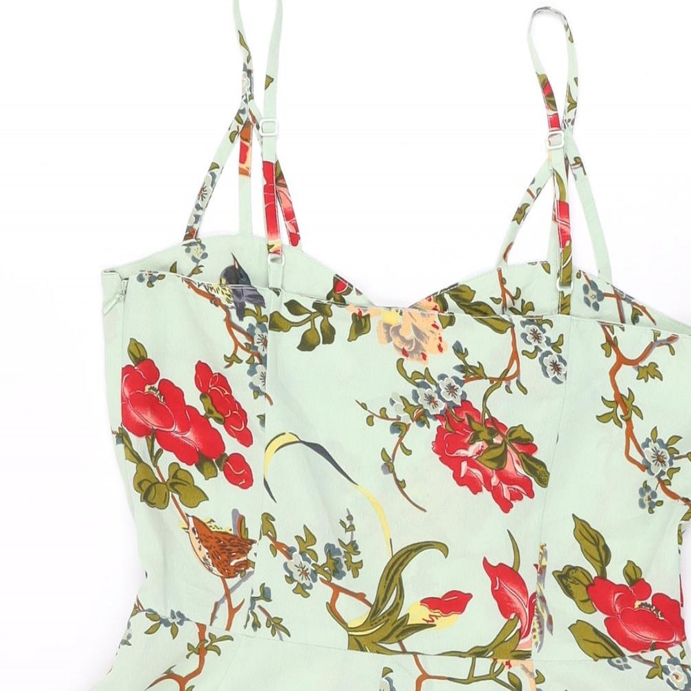 Brand and care label for ASOS women’s green floral polyester playsuit one-piece, size UK 8, 3-inch leg zip