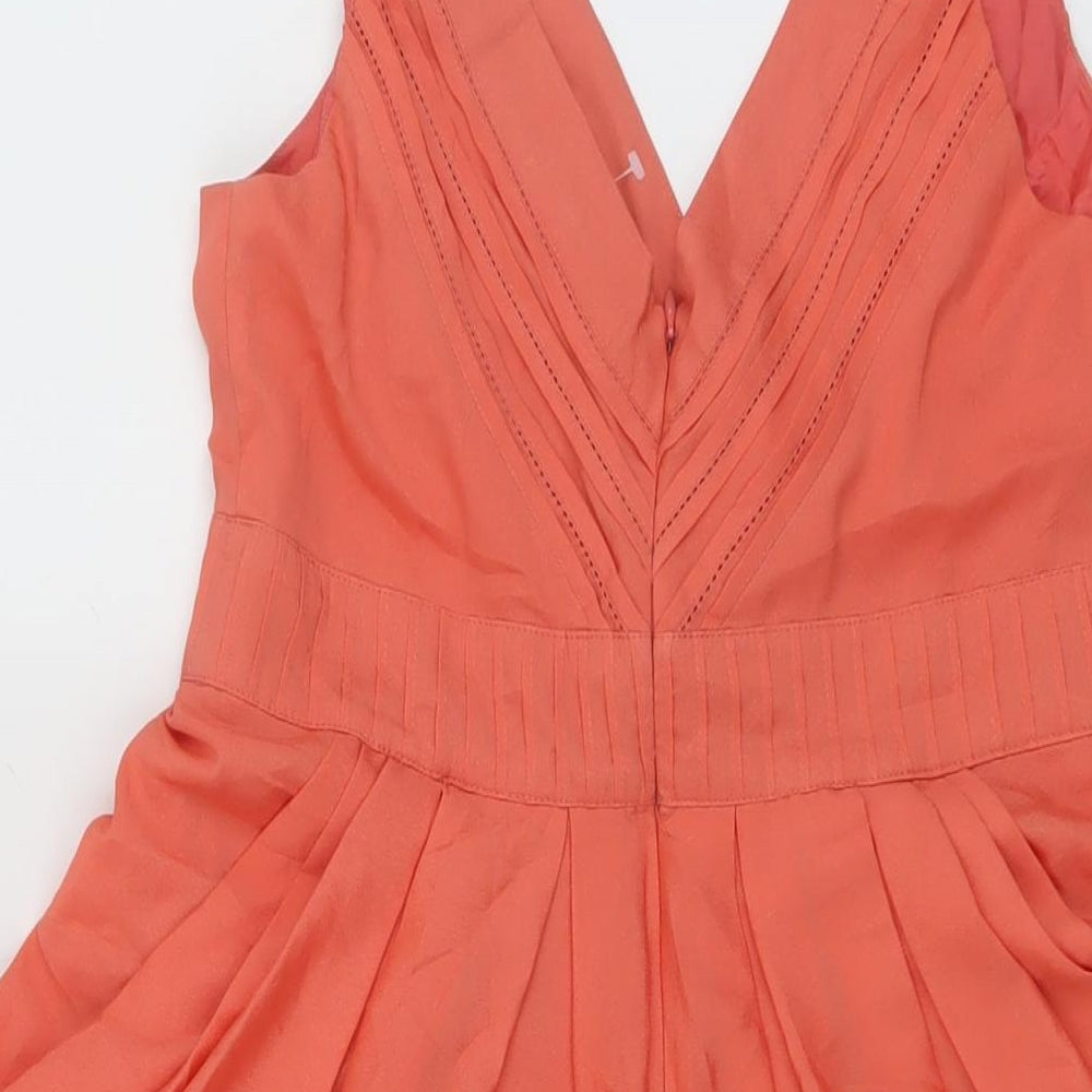 Brand and care label for Red Herring women’s orange polyester mini, size UK 10, v-neck zip