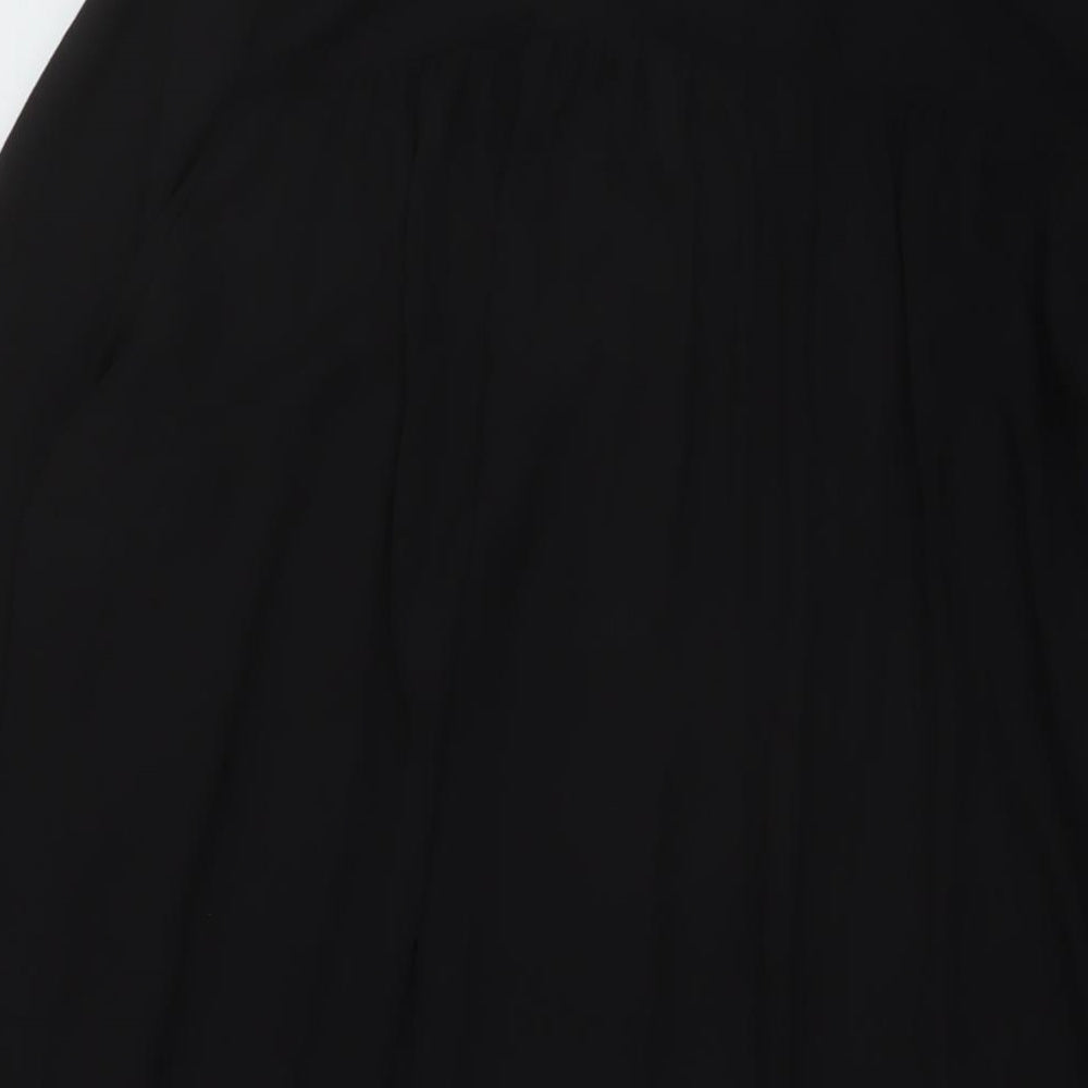 Brand and care label for h7M women’s black polyester tunic blouse, size UK 10, v-neck