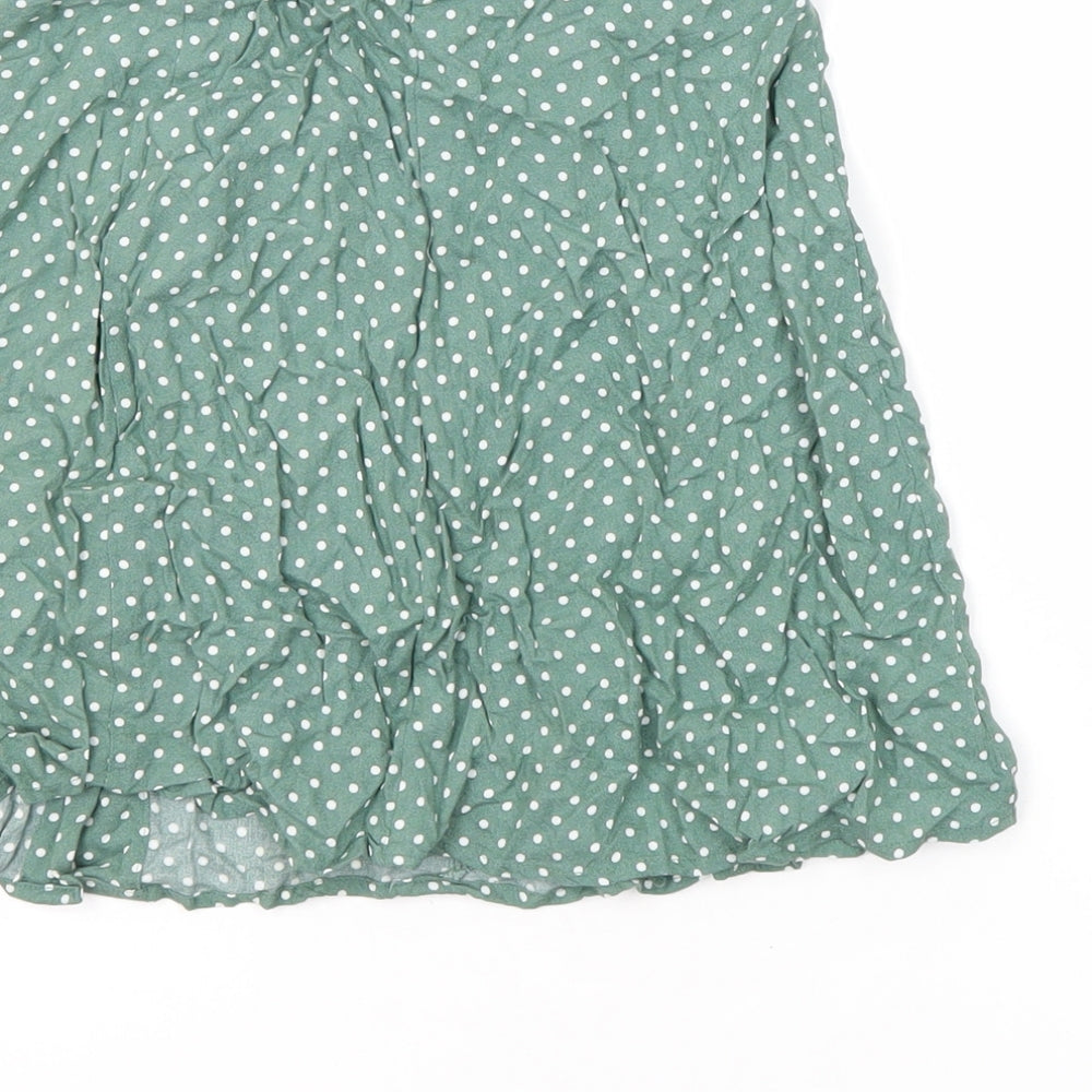 Brand and care label for ASOS women’s multicoloured polka dot viscose mini skirt, size UK 6