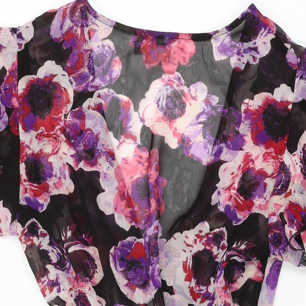 Brand and care label for ASOS women’s black floral polyester playsuit one-piece, size UK 8, tie