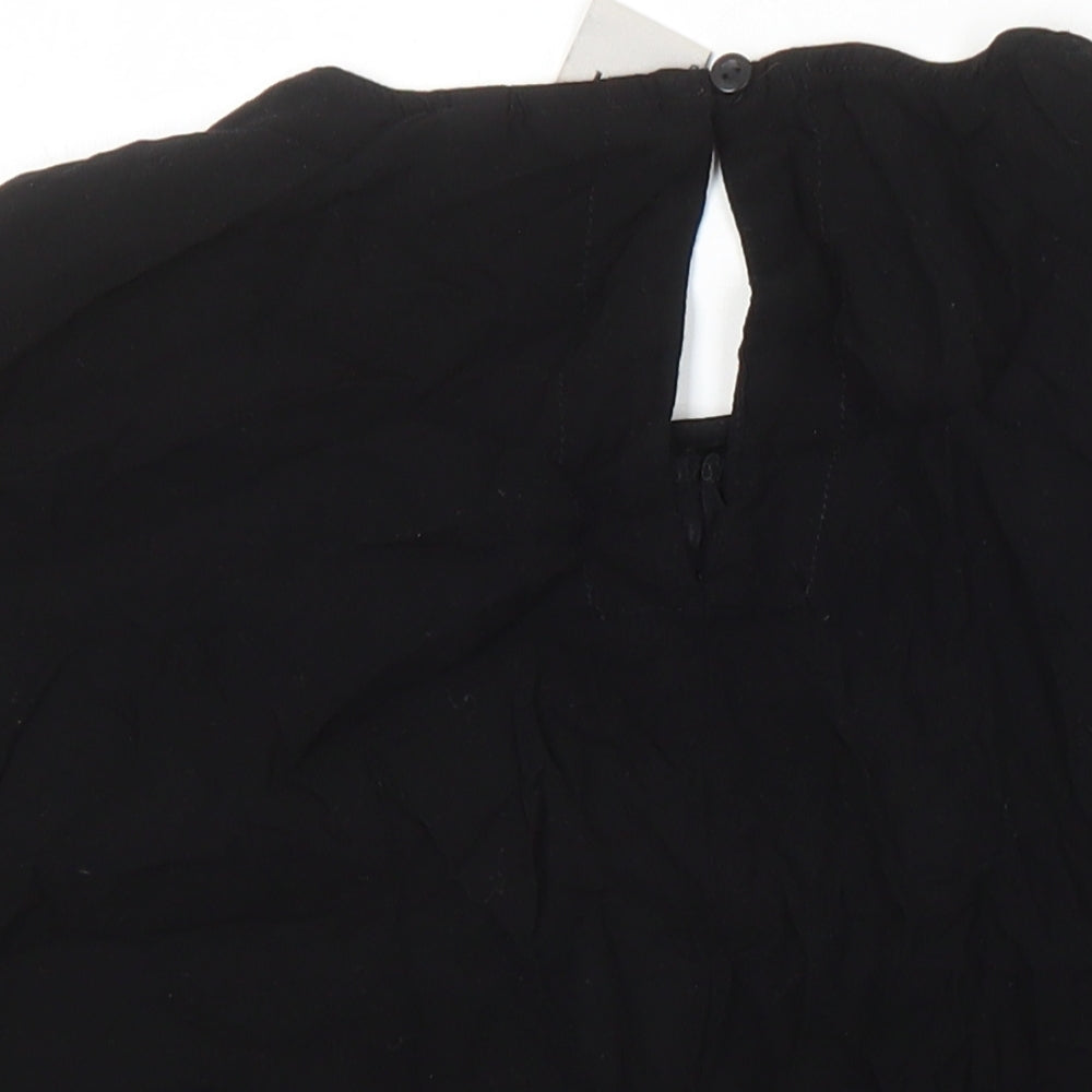Brand and care label for ICHI women’s black polyester blend tunic blouse, size UK 8, round neck