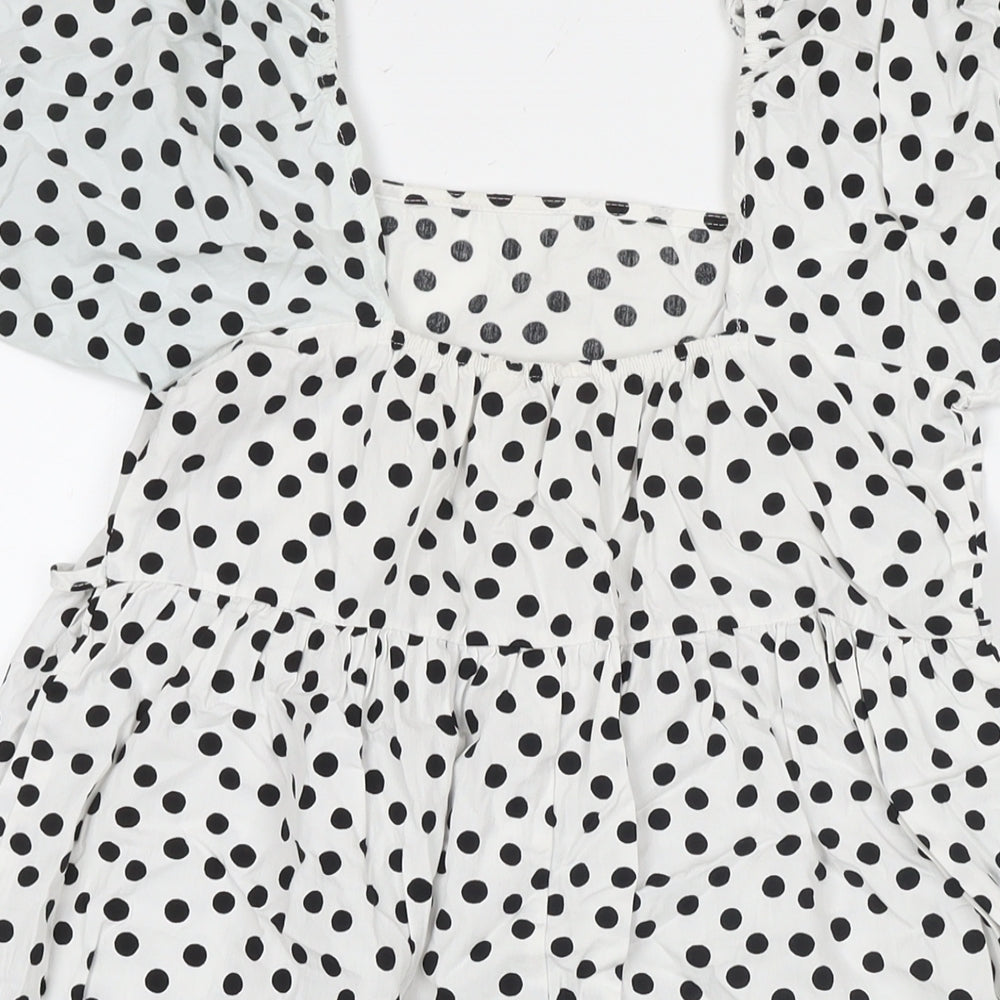 Brand and care label for Miss Selfridge women’s white polka dot cotton a-line, size UK 10, square neck pullover