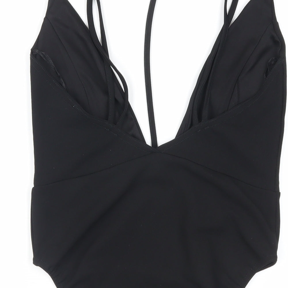 Brand and care label for Missguided women’s black polyester bodysuit one-piece, size UK 10, snap - strappy