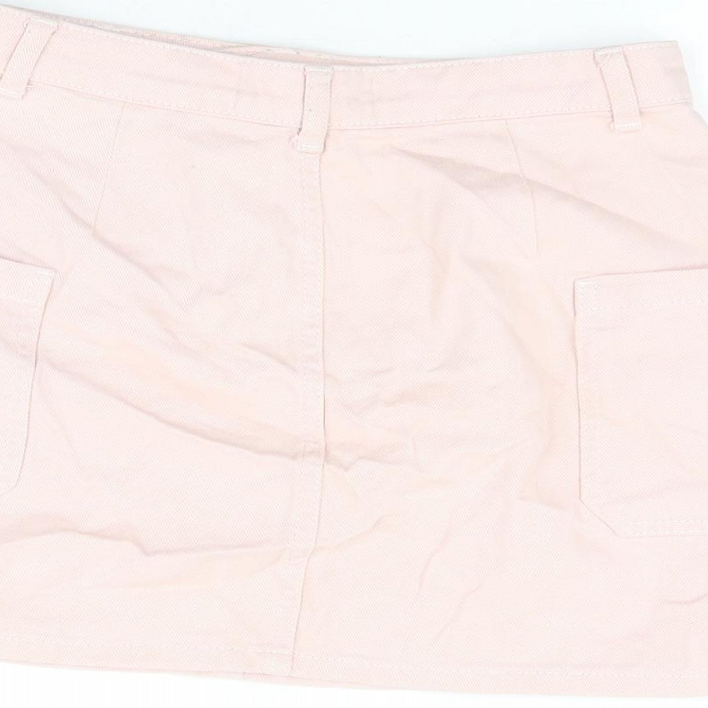 Brand and care label for BDG women’s pink cotton mini skirt, size S, zip