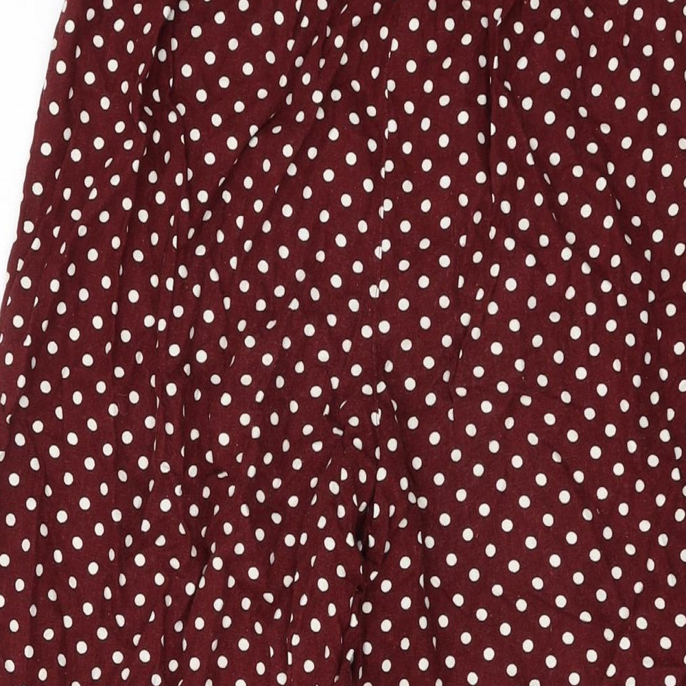 Brand and care label for Miss Selfridge women’s red polka dot viscose trousers, size UK 6, 22-inch leg regular