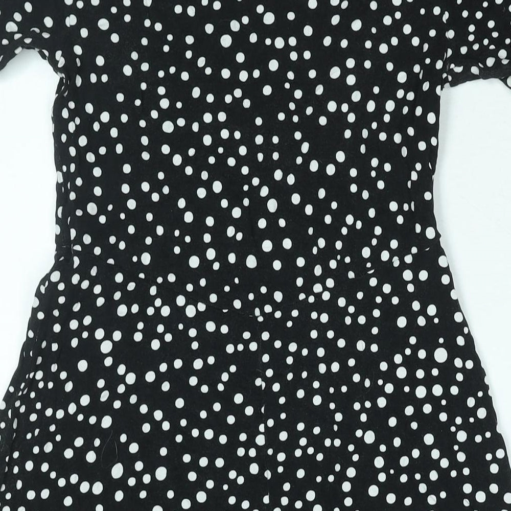Brand and care label for ASOS women’s black polka dot viscose a-line, size UK 10, round neck pullover
