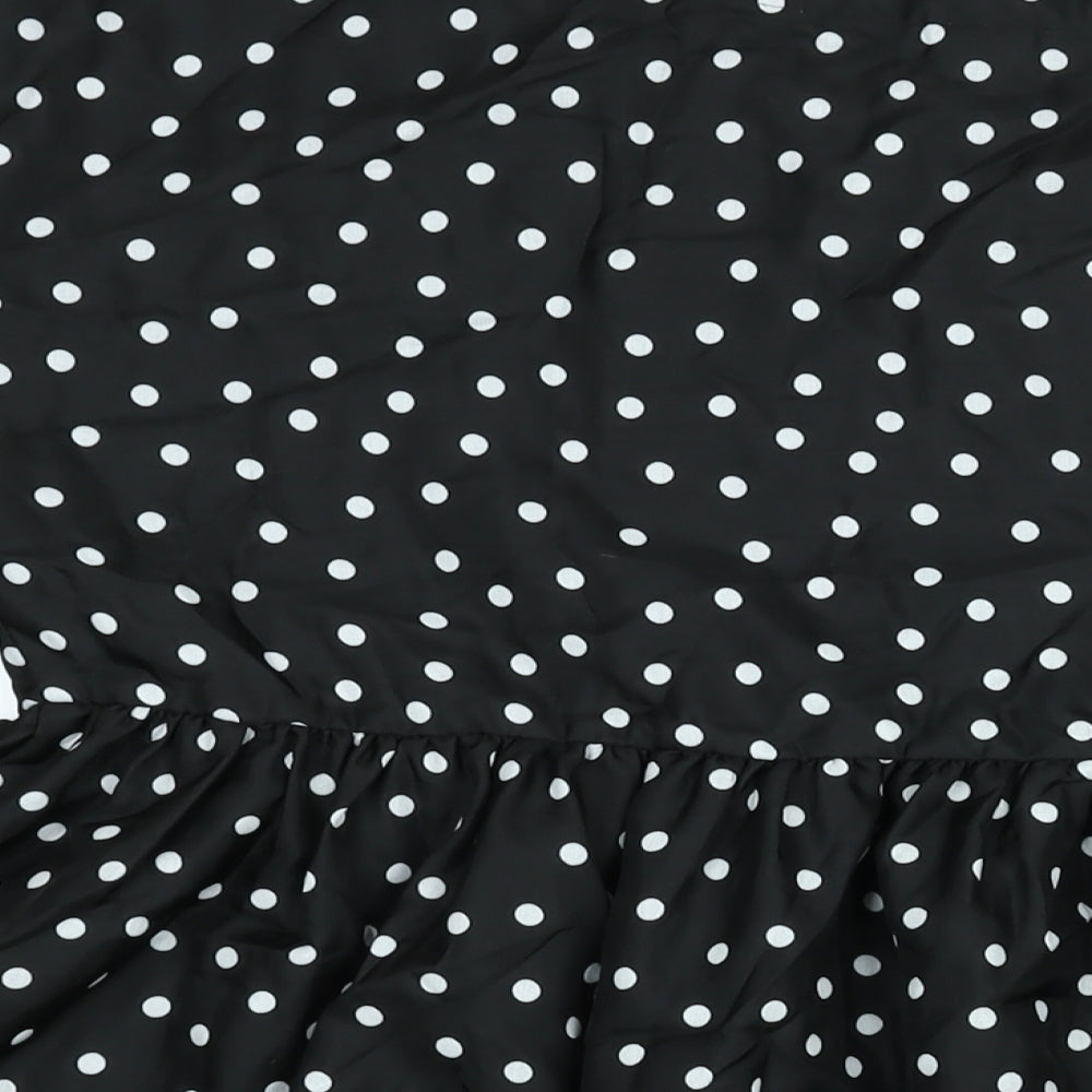Brand and care label for ASOS women’s black polka dot polyester a-line, size UK 12, round neck pullover