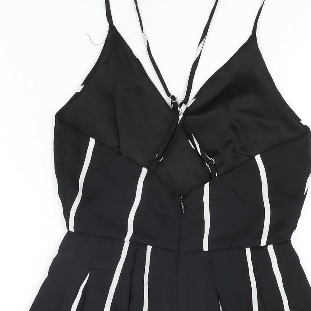 Brand and care label for Missguided women’s black striped polyester playsuit one-piece, size UK 6, zip