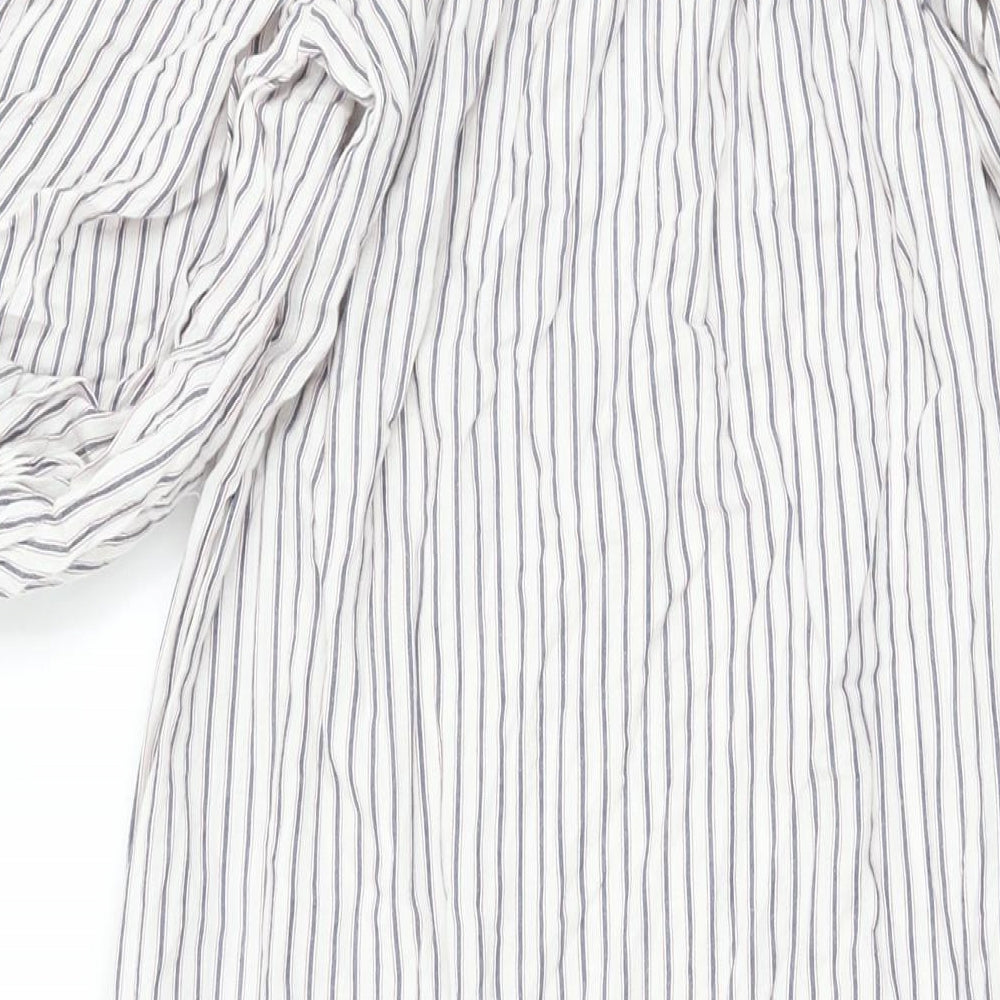 Brand and care label for ASOS women’s white striped polyester a-line, size UK 8, off the shoulder pullover