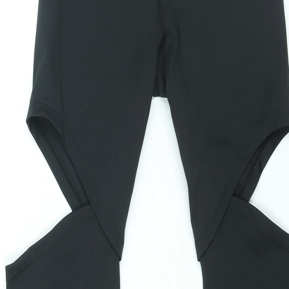Brand and care label for ASOS women’s black polyester compression leggings, size UK 8 regular pullover - cut out detail