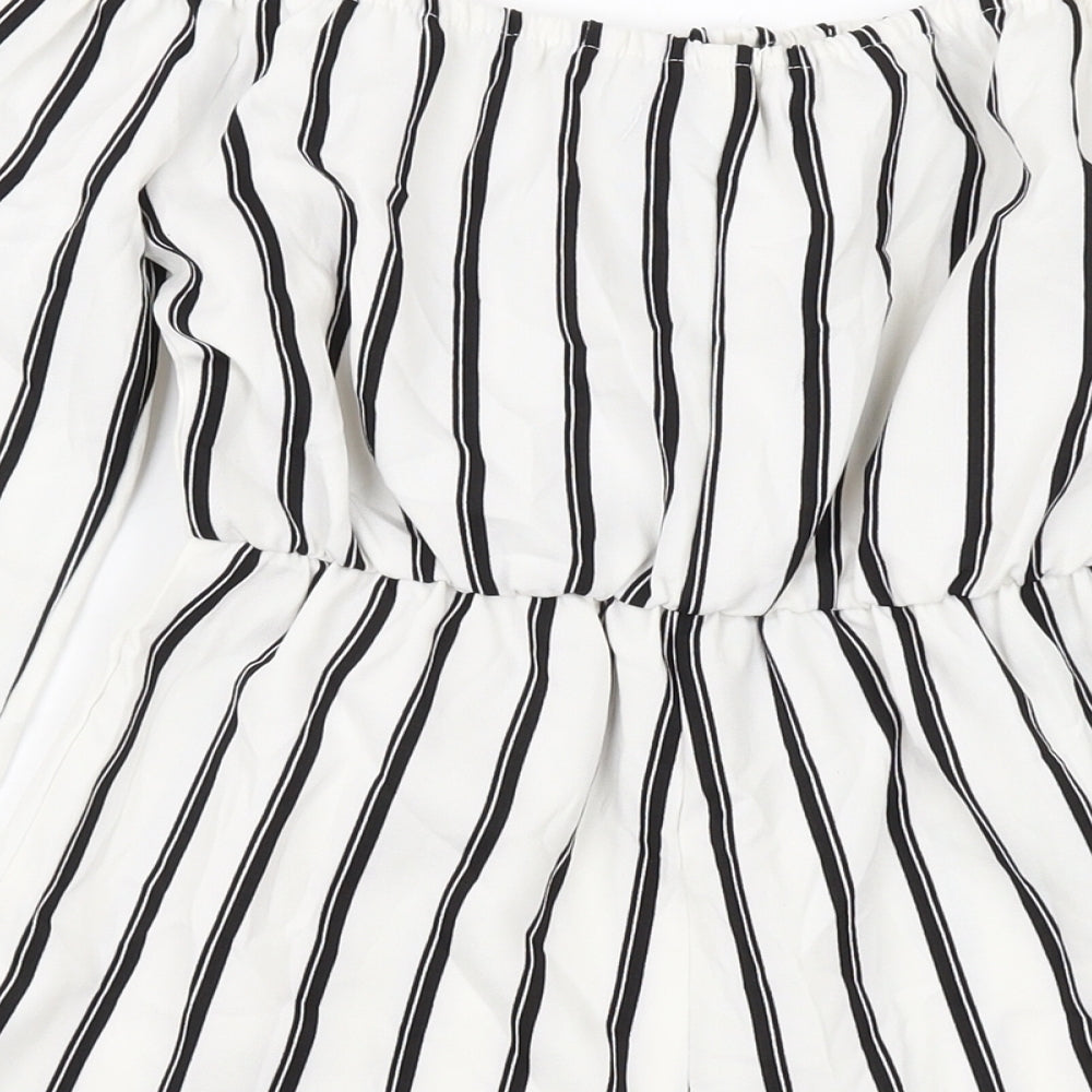 Brand and care label for Missguided women’s ivory striped polyester playsuit one-piece, size UK 4, pullover
