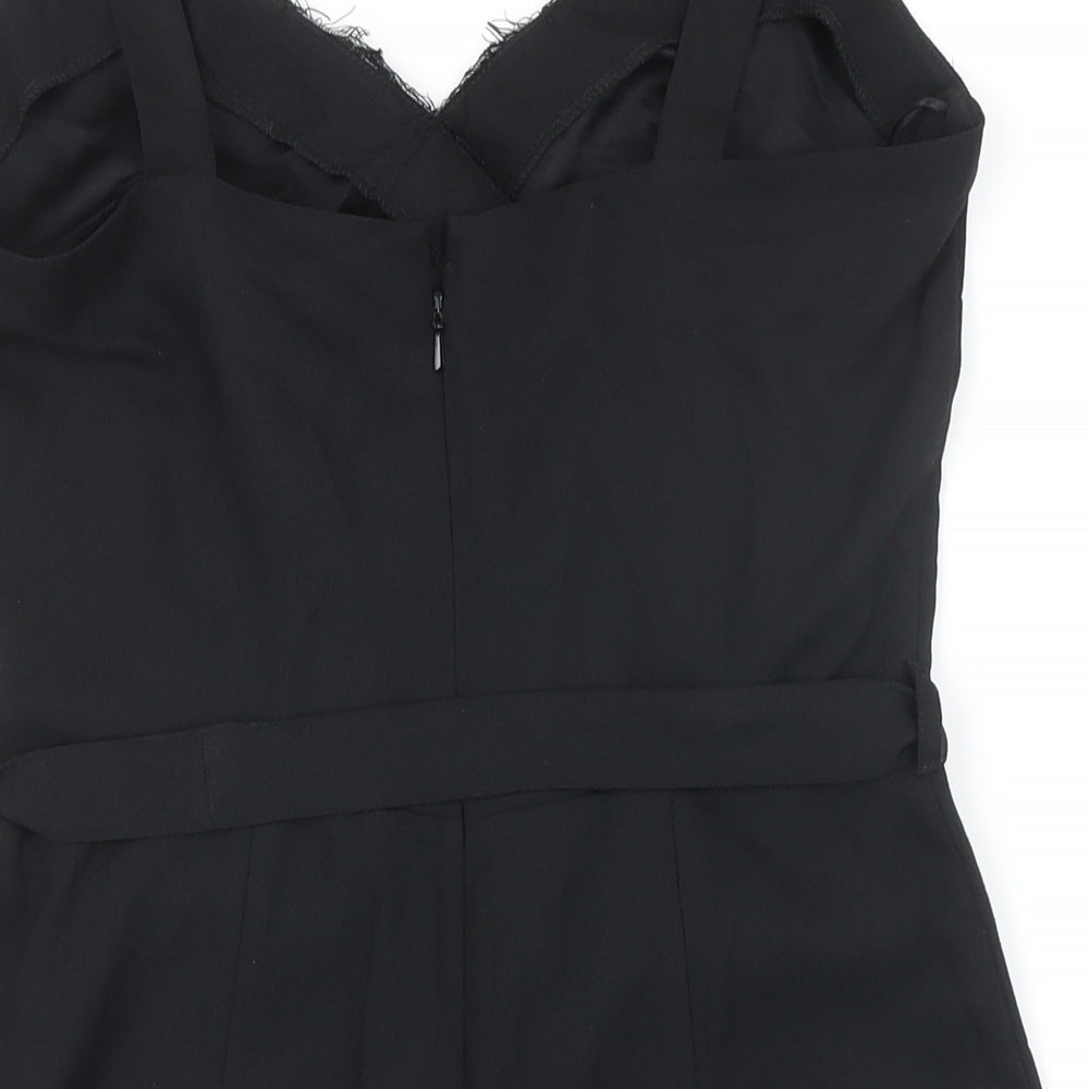 Brand and care label for Miss Selfridge women’s black polyamide playsuit one-piece, size UK 10, zip