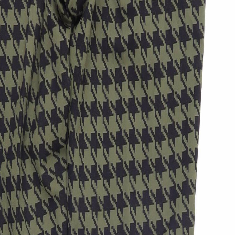 Brand and care label for ASOS women’s green geometric polyamide trousers, size UK 30, in regular zip - houndstooth pattern