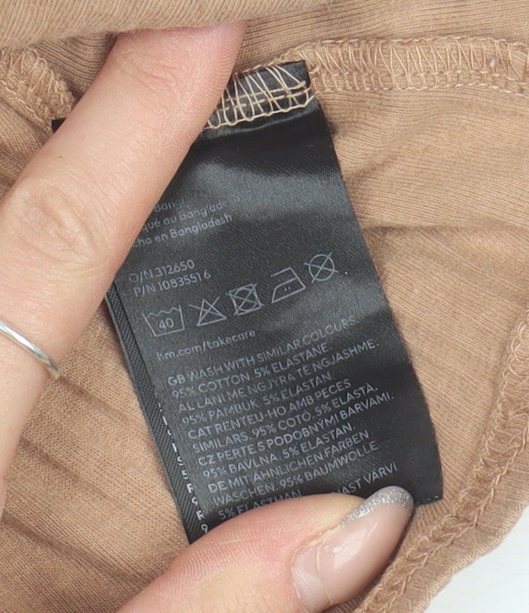 Brand and care label for H&M girls’ brown sleeveless ruffle t-shirt, 6-8 years