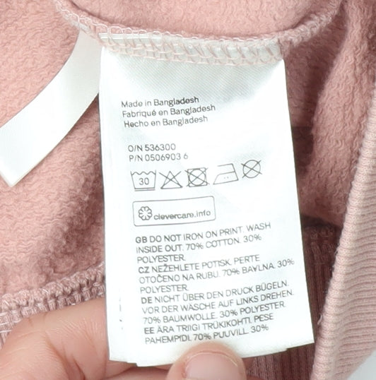 Brand and care label for H&M girls’ pink full zip hoodie, size 14, years, embroidered