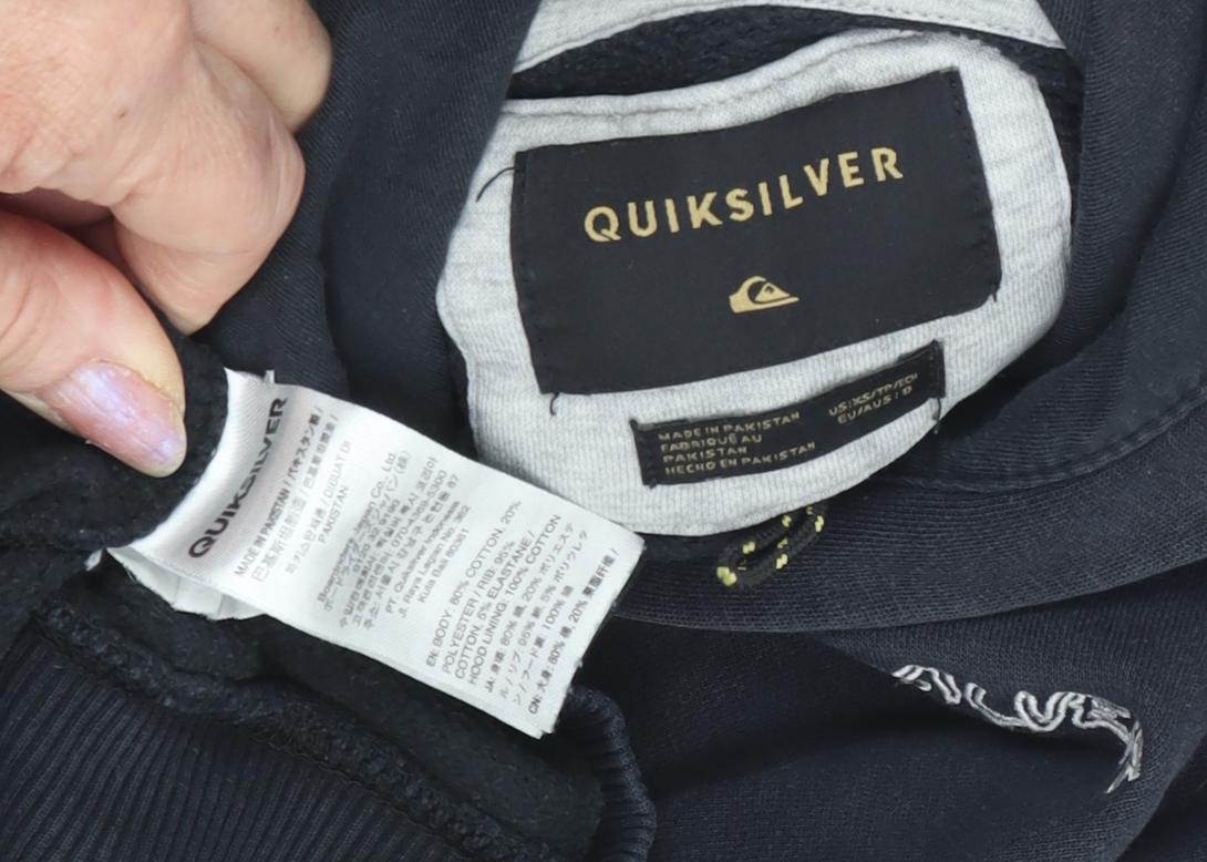 Brand and care label for Quiksilver boys’ black pullover hoodie, size 12
