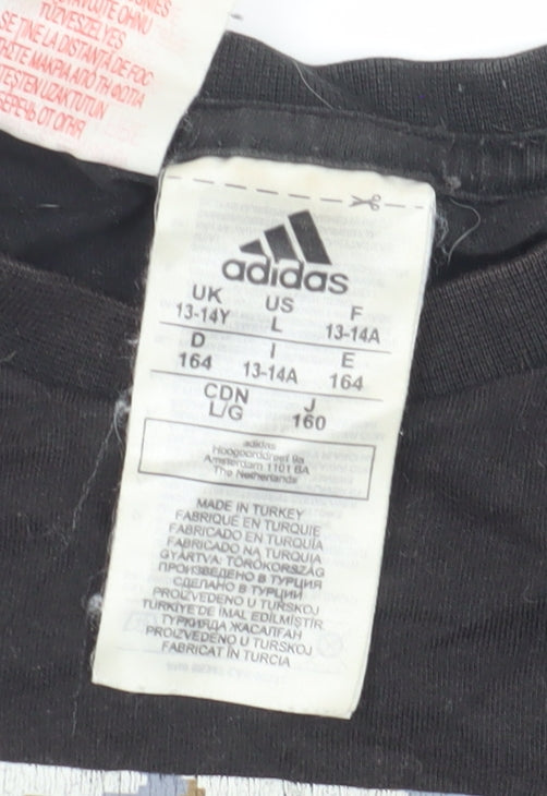 Brand and care label for Adidas boys’ black logo camouflage graphic t-shirt, size 13-14