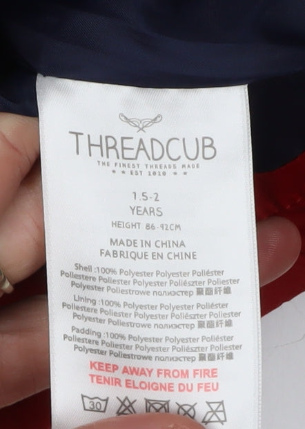 Close-up detail of Threadcub girls’ red hooded puffer jacket 2 years winter wear