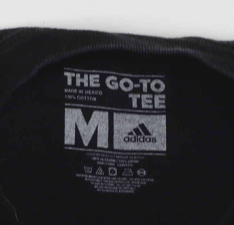 Close-up detail of Adidas boys’ black graphic print t-shirt m casual logo