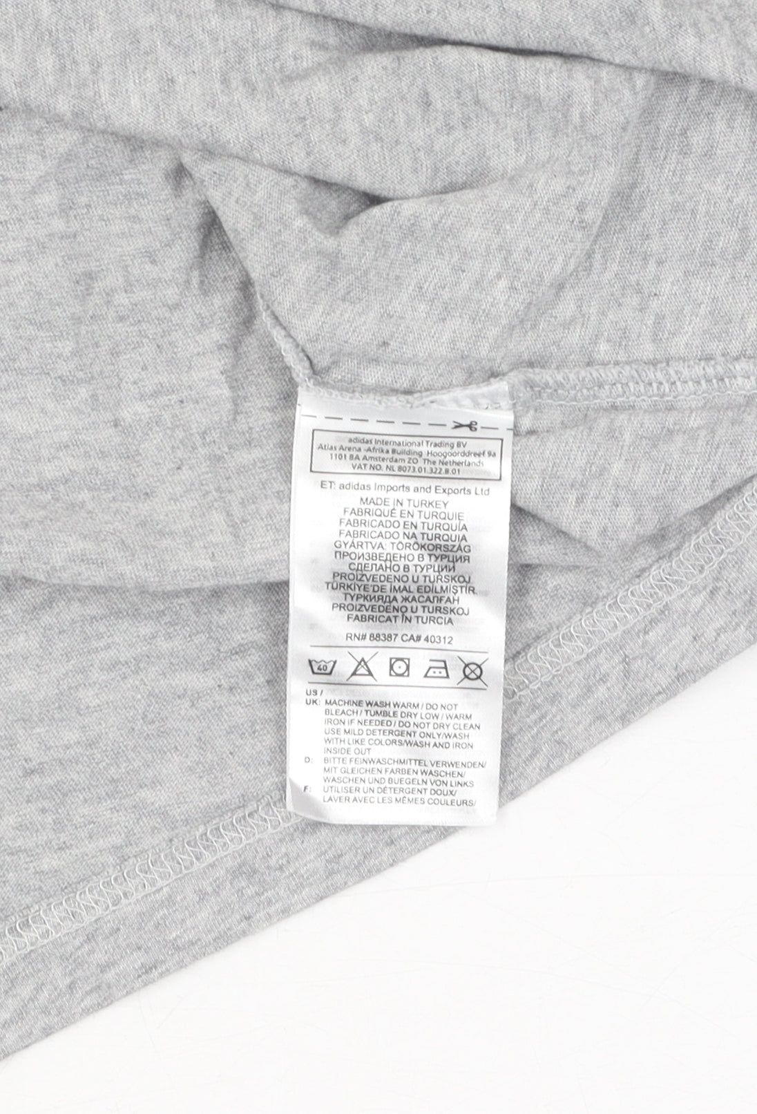 Brand and care label for Adidas girls’ grey t-shirt m 12-14 years with logo accents
