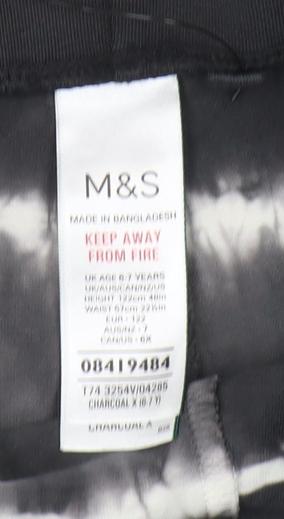 Brand and care label for Marks & Spencer boys’ black compression shorts 6-7 years