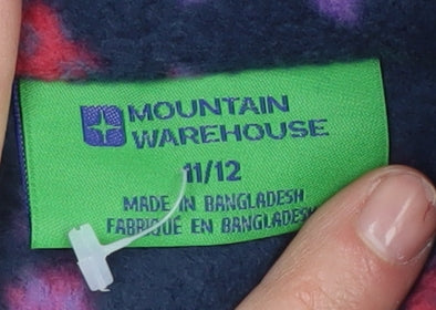 Brand and care label for Mountain Warehouse girls’ multicoloured butterfly fleece pullover 11-12 years