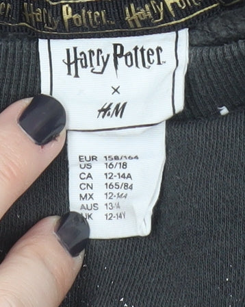 Brand and care label for H&M Harry Potter girls’ black pullover sweatshirt 14 years