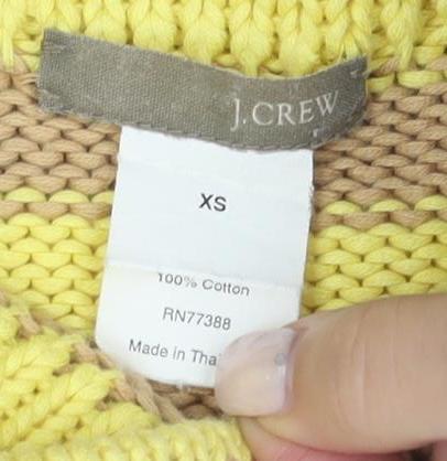 Close-up detail of J.Crew women’s xs striped yellow beige jumper