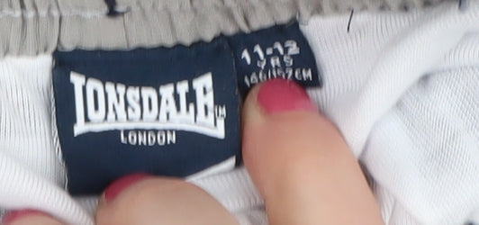 Close-up detail of Lonsdale boys’ blue track pants 11-12 years - sports style