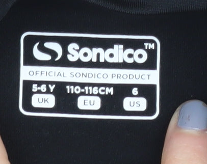 Brand and care label for Sondico girls’ black long sleeve sports jersey 5-6 years