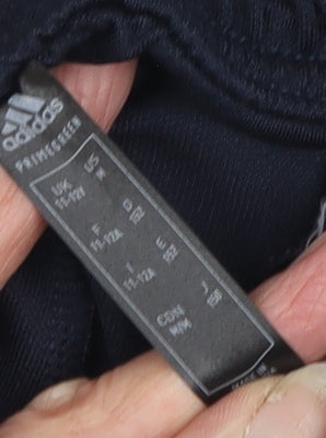 Brand and care label for Adidas boys’ blue track pants 11-12 years regular fit