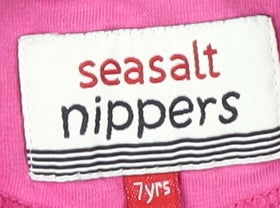 Close-up detail of Seasalt Nippers girls’ pink polo shirt 7 years