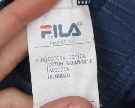 Brand and care label for Fila boys’ blue athletic shorts, age 3, cotton, summer activewear