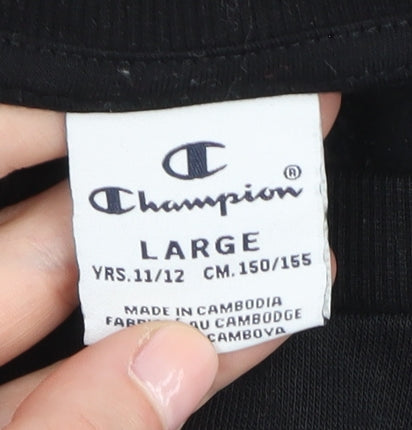 Brand and care label for Champion girls’ black sweatshirt 11y, tunic style, logo detail