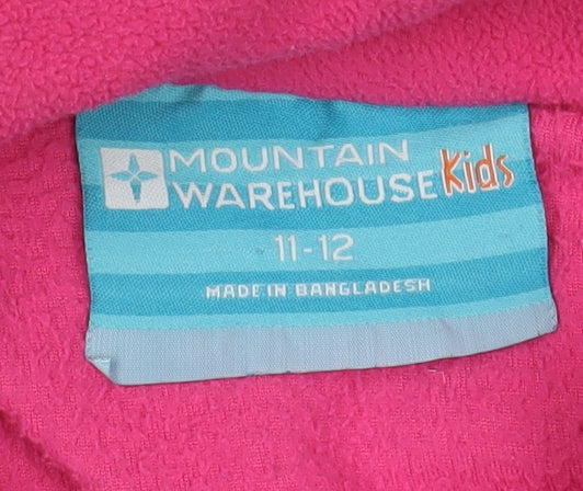 Brand and care label for Mountain Warehouse girls’ pink fleece jacket 11-12 years