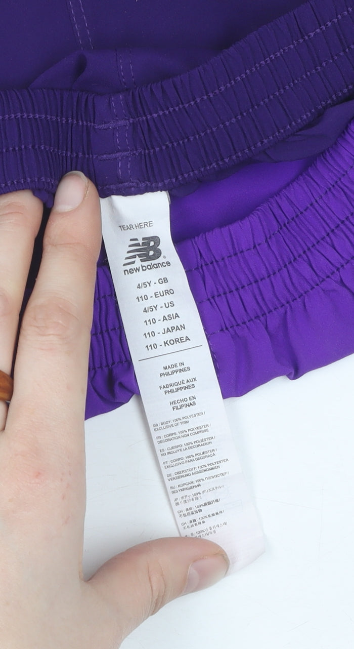 Close-up detail of New Balance boys’ purple athletic football shorts 4-5y