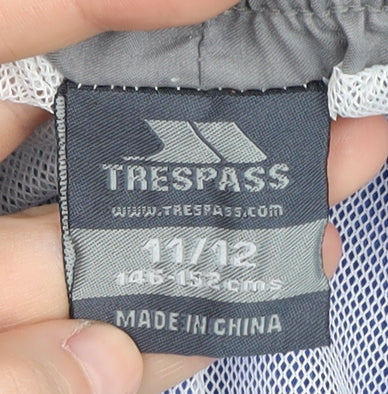 Close-up detail of Trespass boys’ blue swim shorts, size 11, lightweight, elastic waist