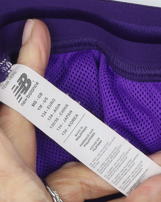Close-up detail of New Balance boys’ purple athletic football shorts 11 years