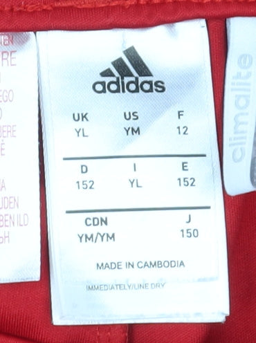 Brand and care label for Adidas boys’ red athletic shorts 11-12 years