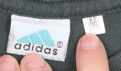 Close-up detail of Adidas boys’ black medium graphic print t-shirt