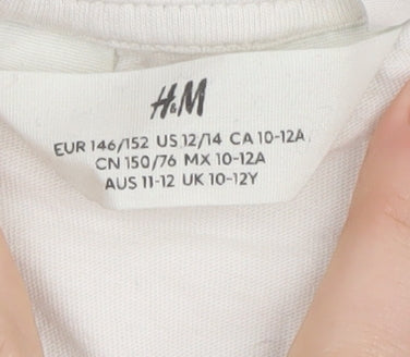 Brand and care label for H&M girls’ white graphic t-shirt, size 11, years, harry potter