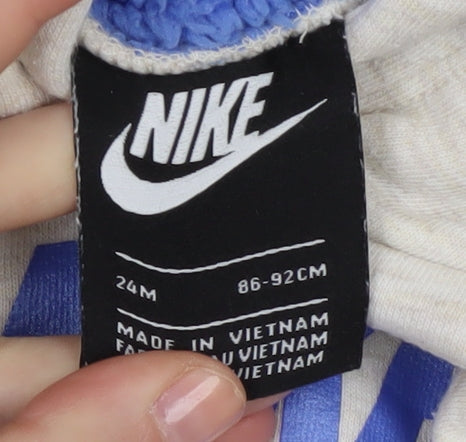 Brand and care label for Nike boys’ beige hoodie pullover fleece lined, size 2, years