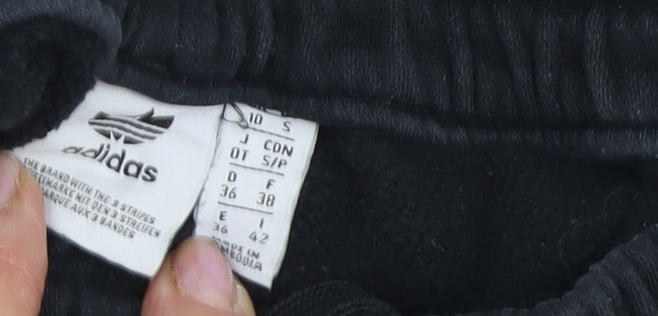 Close-up detail of Adidas boys’ black track pants s - elastic waist, side stripe