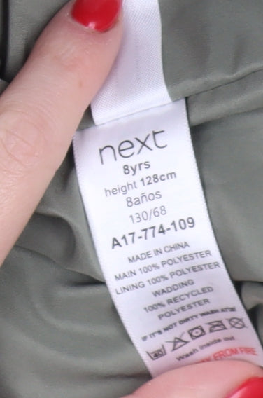 Close-up detail of Next girls’ green hooded puffer jacket, size 8