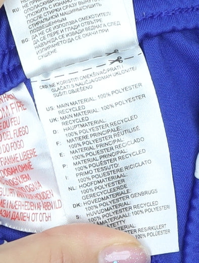 Brand and care label for Adidas boys’ blue athletic football shorts 5-6 years