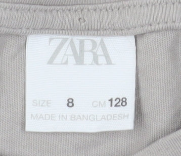 Brand and care label for Zara girls’ grey dalmatians graphic long sleeve t-shirt, size 8