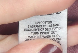 Brand and care label for Tahari girls’ pink crochet sleeve blouse, 4-5 years
