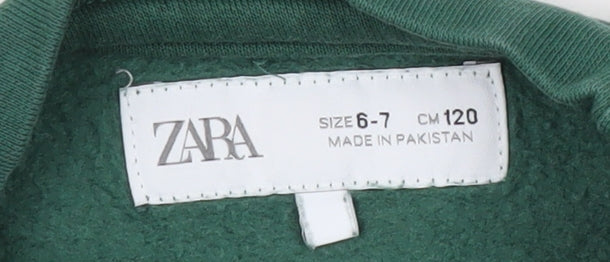 Brand and care label for Zara boys’ green crew neck pullover sweatshirt, size 6-7